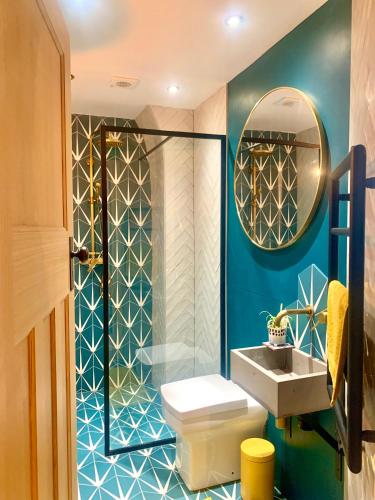 a bathroom with a toilet and a sink and a mirror at Station Masters Cottage in Hope