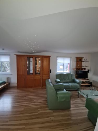 a living room with a couch and a table at Haus Fernblick in Kurort Bärenburg