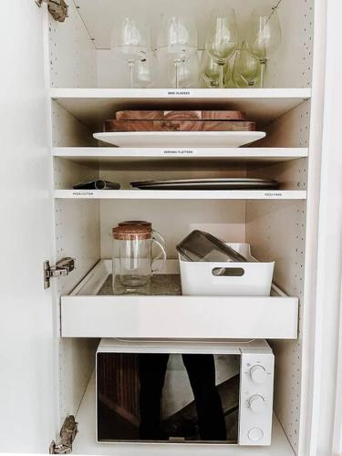 a white refrigerator with a cupboard filled with items at Okt Häus in Nordegg