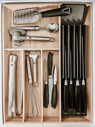 a wooden drawer filled with cooking utensils at Okt Häus in Nordegg