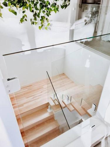 a glass staircase in a house with wooden floors at Okt Häus in Nordegg