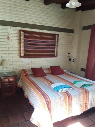 a bedroom with a large bed with a window at La Tranquera Alquiler Temporario in Cafayate