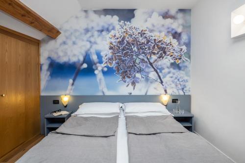 Postel nebo postele na pokoji v ubytování Pippo Hotel
