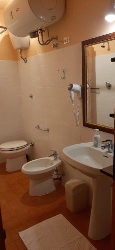 a bathroom with a sink and a toilet and a mirror at Casetta all'Abetone Jacopo e Sabrina in Abetone