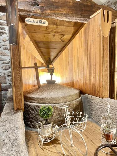 a bike parked in a room with a fountain at Moinho de Brião in Montalegre