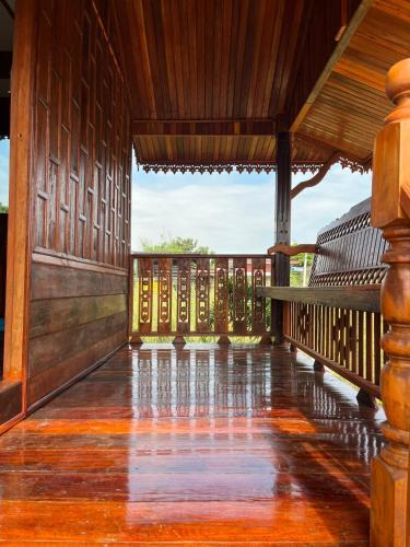 a porch of a building with a wooden floor at Rachatadapa Village in Ban Khao Laem