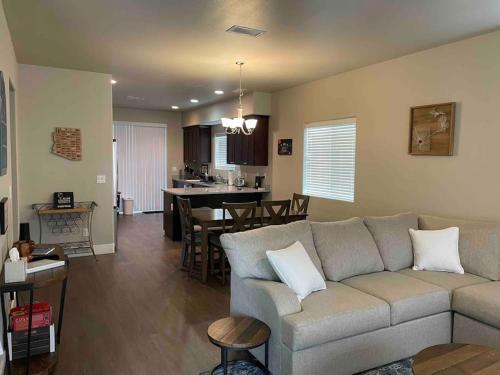 a living room and dining room with a couch and a kitchen at Family friendly 4-bdrm 3.5 bath w guest suite in Flagstaff
