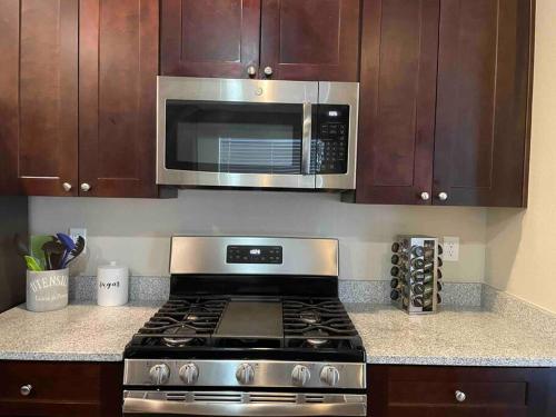 a kitchen with a stove and a microwave at Family friendly 4-bdrm 3.5 bath w guest suite in Flagstaff