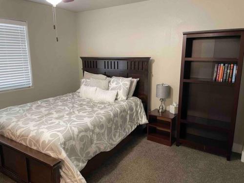 a bedroom with a large bed and a book shelf at Family friendly 4-bdrm 3.5 bath w guest suite in Flagstaff