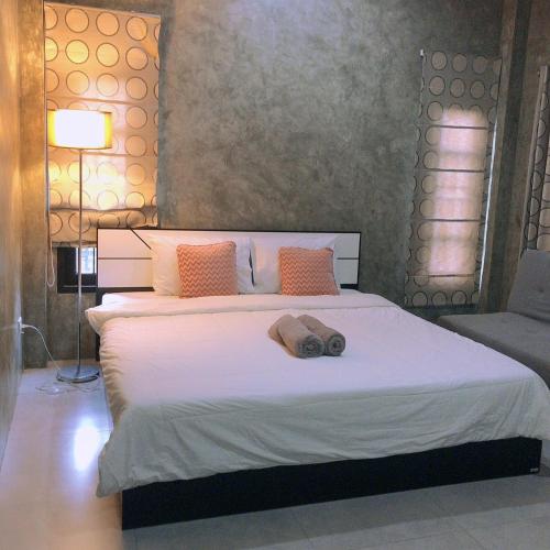 a bedroom with a large bed with a pillow on it at PK Villa Huahin in Hua Hin