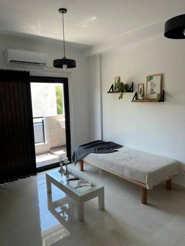 a bedroom with a bed and a table and a window at Departamento de 1 dormitorio. in Corrientes