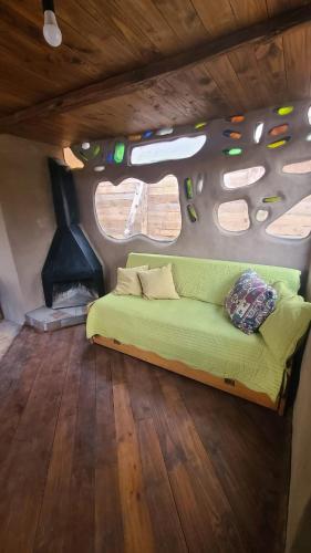 a couch in the middle of a room with a fireplace at Casita entre dunas al son del mar in Salinas 