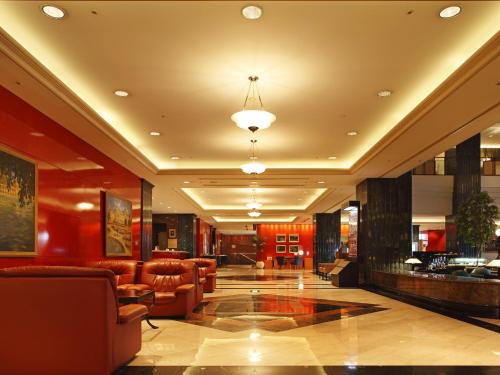 a lobby with chairs and a bar in a building at Hotel East 21 Tokyo in Tokyo