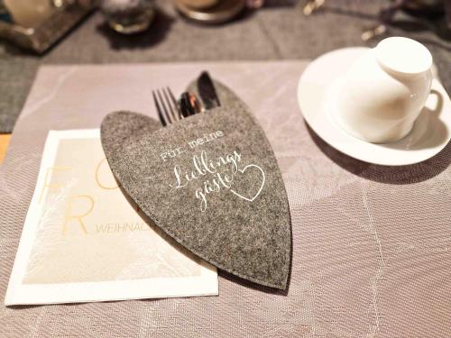 a heart shaped napkin sitting on top of a table at Gästehaus Funk in Greetsiel