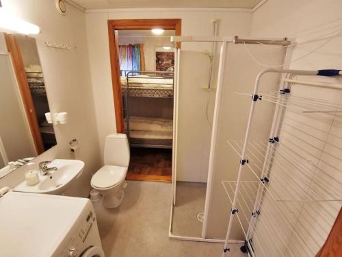 a bathroom with a toilet and a sink and a shower at Small Basement Apartment Private Entrance Nice View in Fitjar