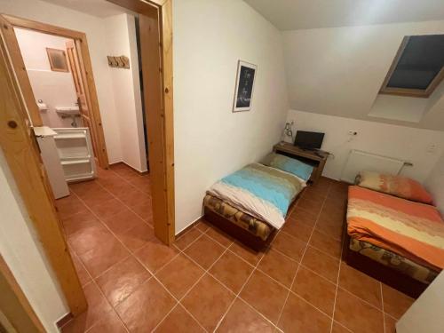 a small room with two beds and a desk at penzión Brooklyn in Skalica