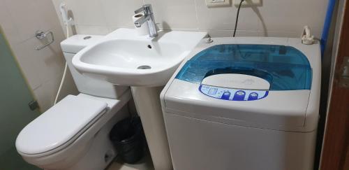 a small bathroom with a toilet and a sink at Tripleview luxurious eton baypark manila in Manila