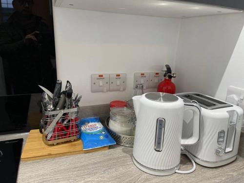 a kitchen counter with a toaster on a counter top at Premier 1 Bed Studio B in Broxburn