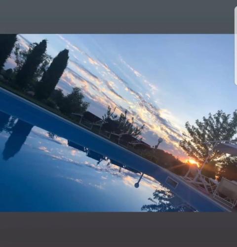 a view of a swimming pool at sunset at Villa Lara in Marsaglia