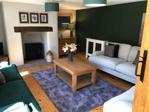 a living room with a couch and a coffee table at Beautiful mews cottage. Ledbury town centre. in Ledbury