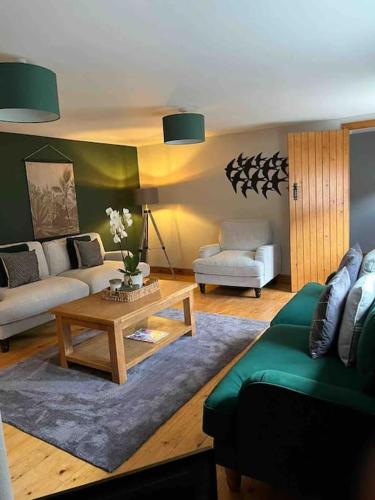 a living room with a couch and a coffee table at Beautiful mews cottage. Ledbury town centre. in Ledbury