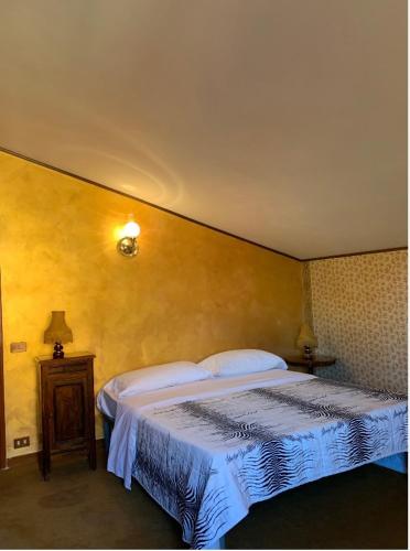 a bedroom with a large bed and a table at Villa Massimo in Albano Laziale