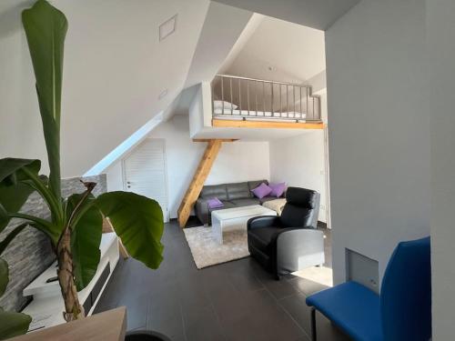 a living room with a couch and a chair at Apartment Sofia in Idrija