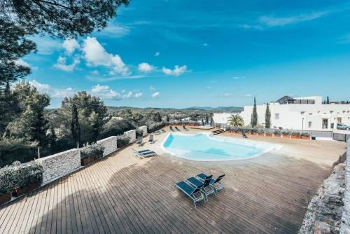 a swimming pool on a roof with lounge chairs at Luxusvilla Casaabel in Roca Llisa