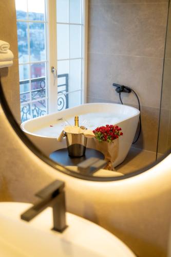 a bathroom with a bath tub and a sink at Downtown Apartments in Pristina