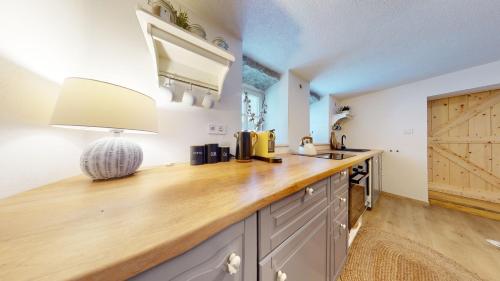 a kitchen with a wooden counter top and a sink at Romantická chalupa s krbem in Hořice na Šumavě