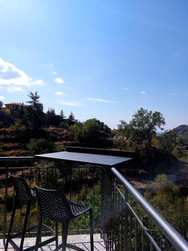 two chairs and a table on a balcony with a view at Agros Green Valley Suites in Limassol