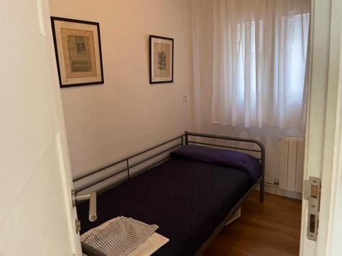 a small bed in a room with a window at 3 bedrooms appartement with wifi at Valencia 3 km away from the beach in Valencia