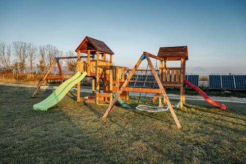 a group of playground equipment in the grass at Atelier Recreation Village in Râşnov