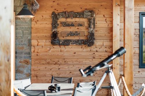 a room with a wooden wall with a sign on it at Atelier Recreation Village in Râşnov