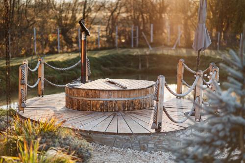 a wooden deck with a wooden barrel and a swing at Atelier Recreation Village in Râşnov