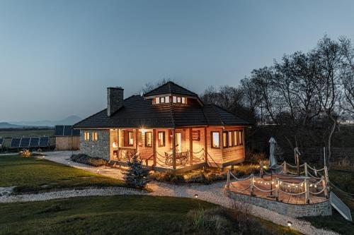 a large wooden house with lights on it at Atelier Recreation Village in Râşnov