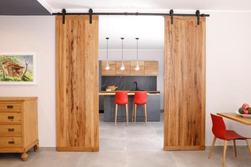 a kitchen with wooden sliding doors in a room at Affittacamere Casa Maria in San Giovanni Ilarione