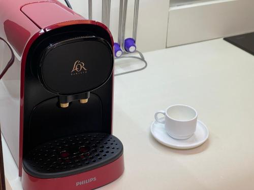 a coffee maker with a cup on a table at Piso en el centro de Alcoy para sentirte en casa in Alcoy