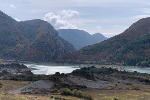 a view of a river with mountains in the background at Loft Casa Bergua in Arguis