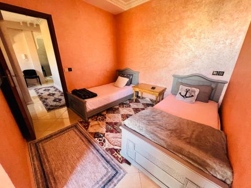 a small room with two beds and a mirror at Julie's Private Apartment in Marrakech