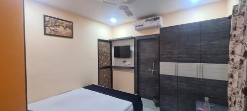 a small room with a bed and a tv at HOTEL MANORAMA PALACE in Dhanbād