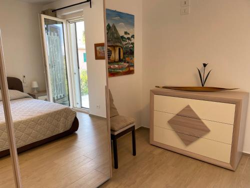 a bedroom with a bed and a dresser and a mirror at VILLA DALU not only Holidays in Trani
