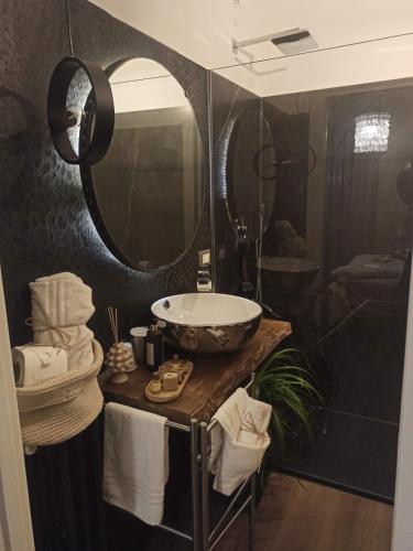 a bathroom with a sink and a large mirror at CHEZMOI (da me) in Matera