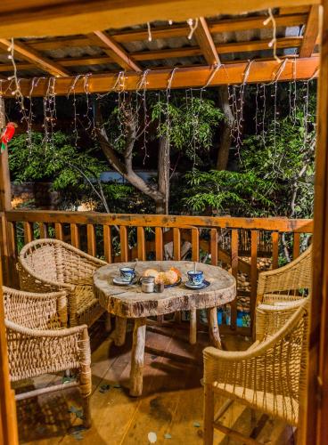 a table and chairs sitting on a porch with a table and chairs at Hotel Colibri in Mineral de Pozos
