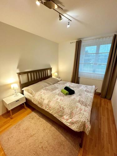a bedroom with a bed with a green hat on it at Sternenhimmel Gamlitz FeWo 3 SZ in Gamlitz