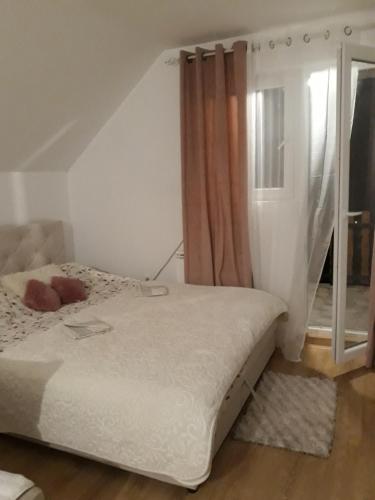 a bedroom with a bed and a window at Holiday home BOŽUR in Kolašin