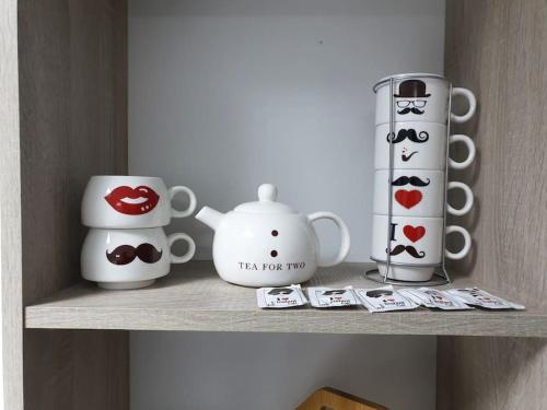 a shelf with tea pots and cups on it at The jewel of the coast in Sousse