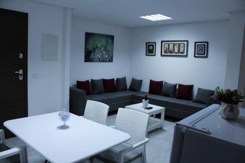 a living room with a couch and a table and chairs at The jewel of the coast in Sousse