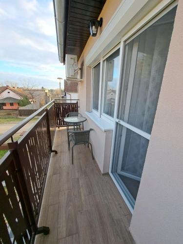 a balcony with a table and chairs on it at Apartments Manna Palic in Palić