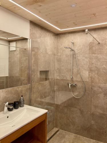 a bathroom with a shower and a sink at Haus Glasella in Schruns-Tschagguns